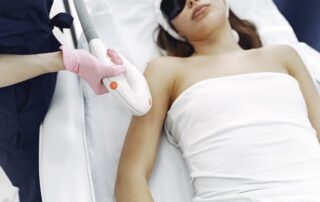woman receiving laser hair removal on her arm