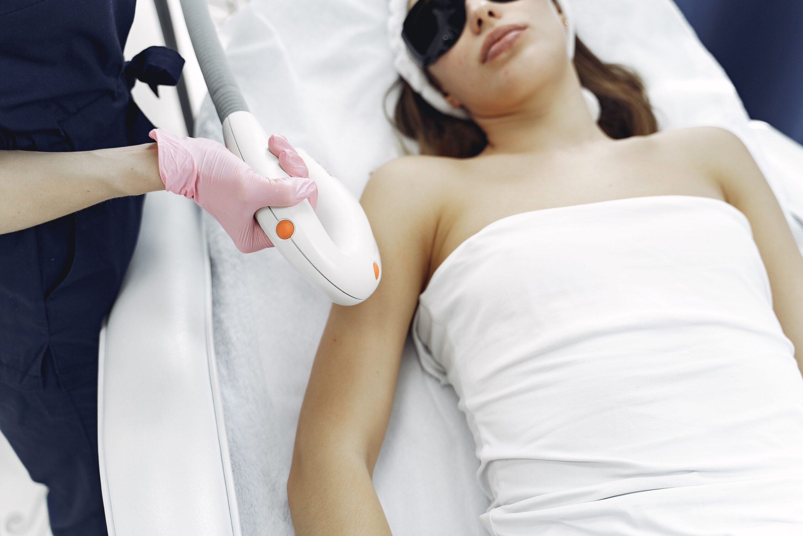 woman receiving laser hair removal on her arm